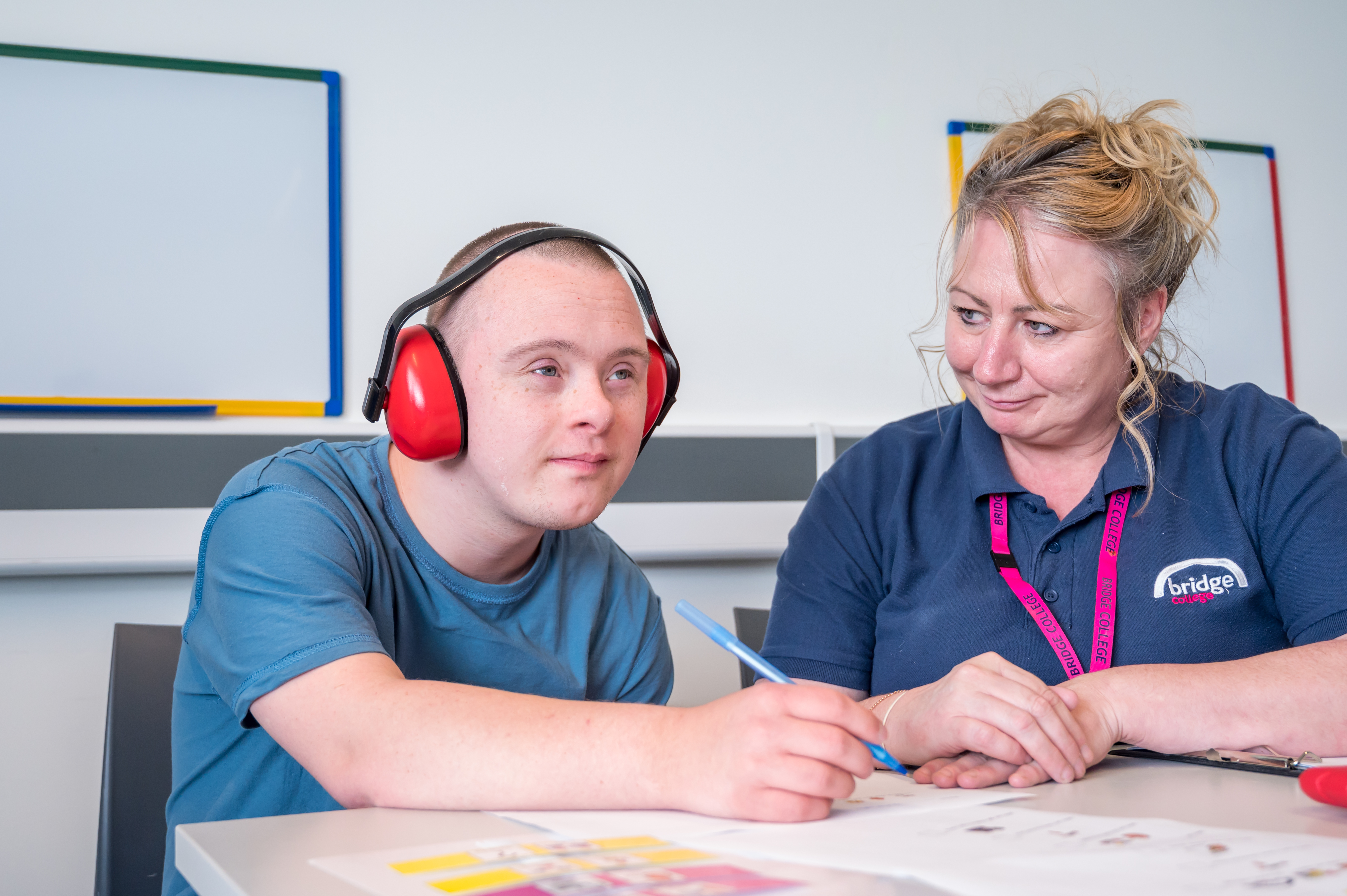 A Bridge student working with a teaching assistant