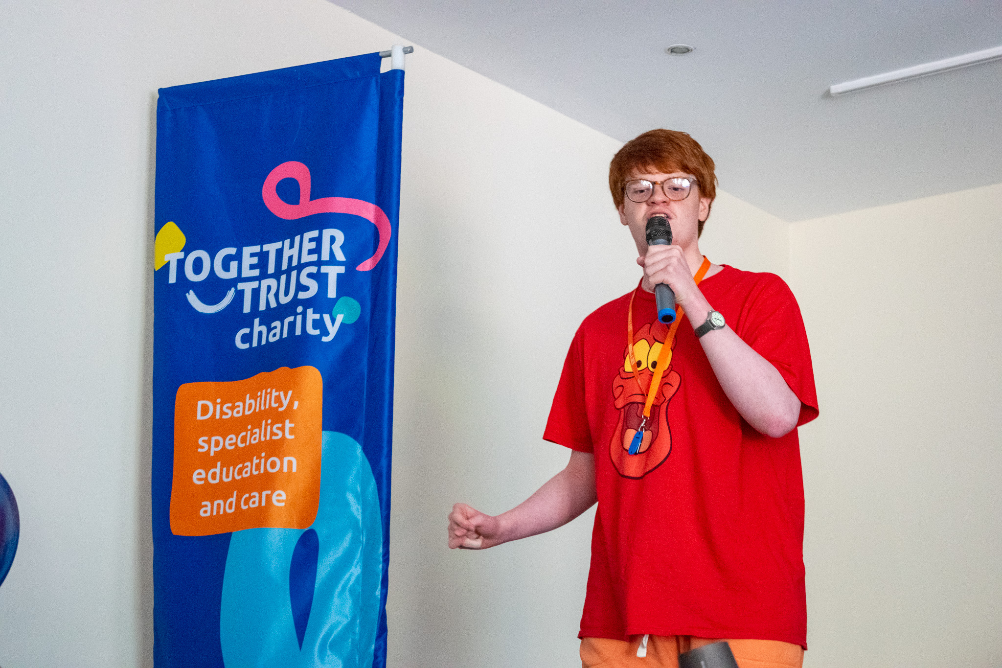 teen boy singing on a stage 