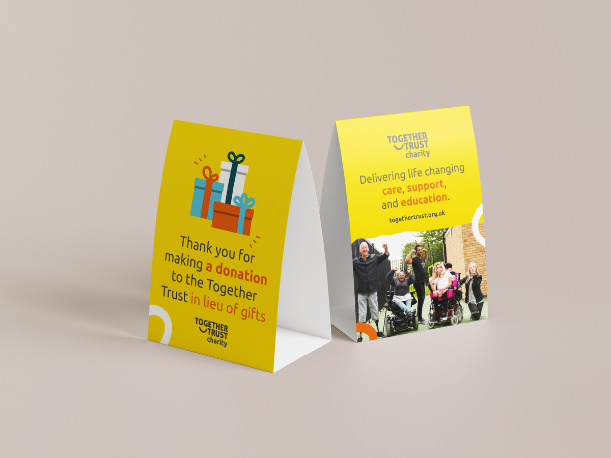 Yellow table top stands with information about the Together Trust on
