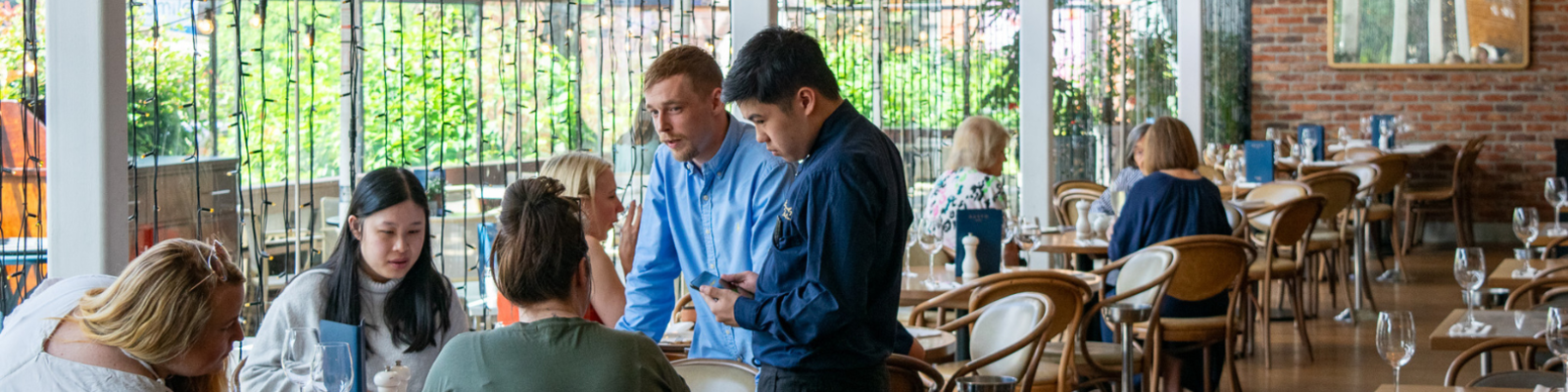 Student practicing customer service skills at Gusto restaurant.