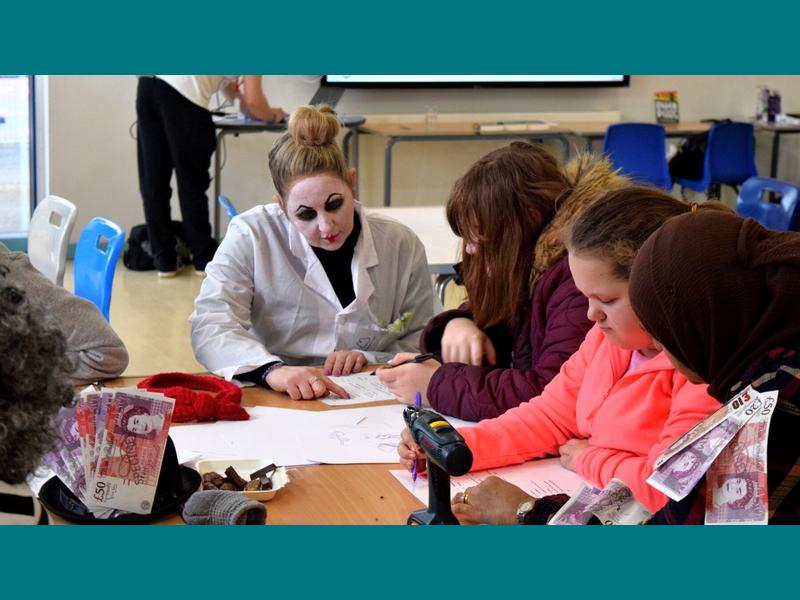 A group of students with a staff member dressed as Demon Dentist during the writing workshop.