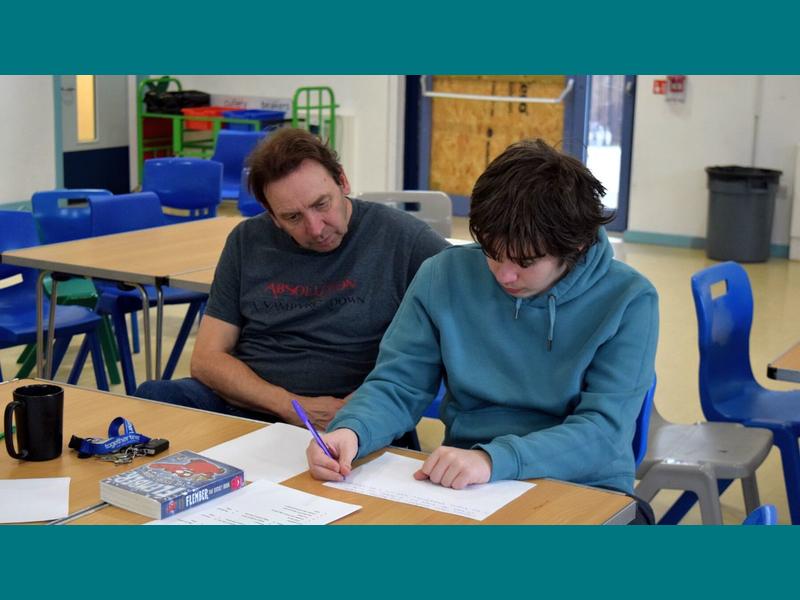 A staff member and student during the writing workshop.