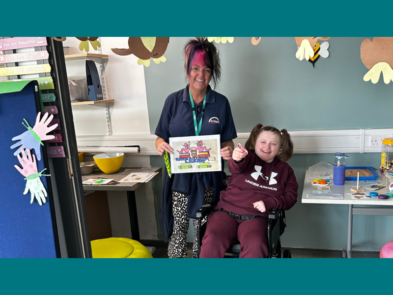 Millie and her support worker showing off the winning sign! 