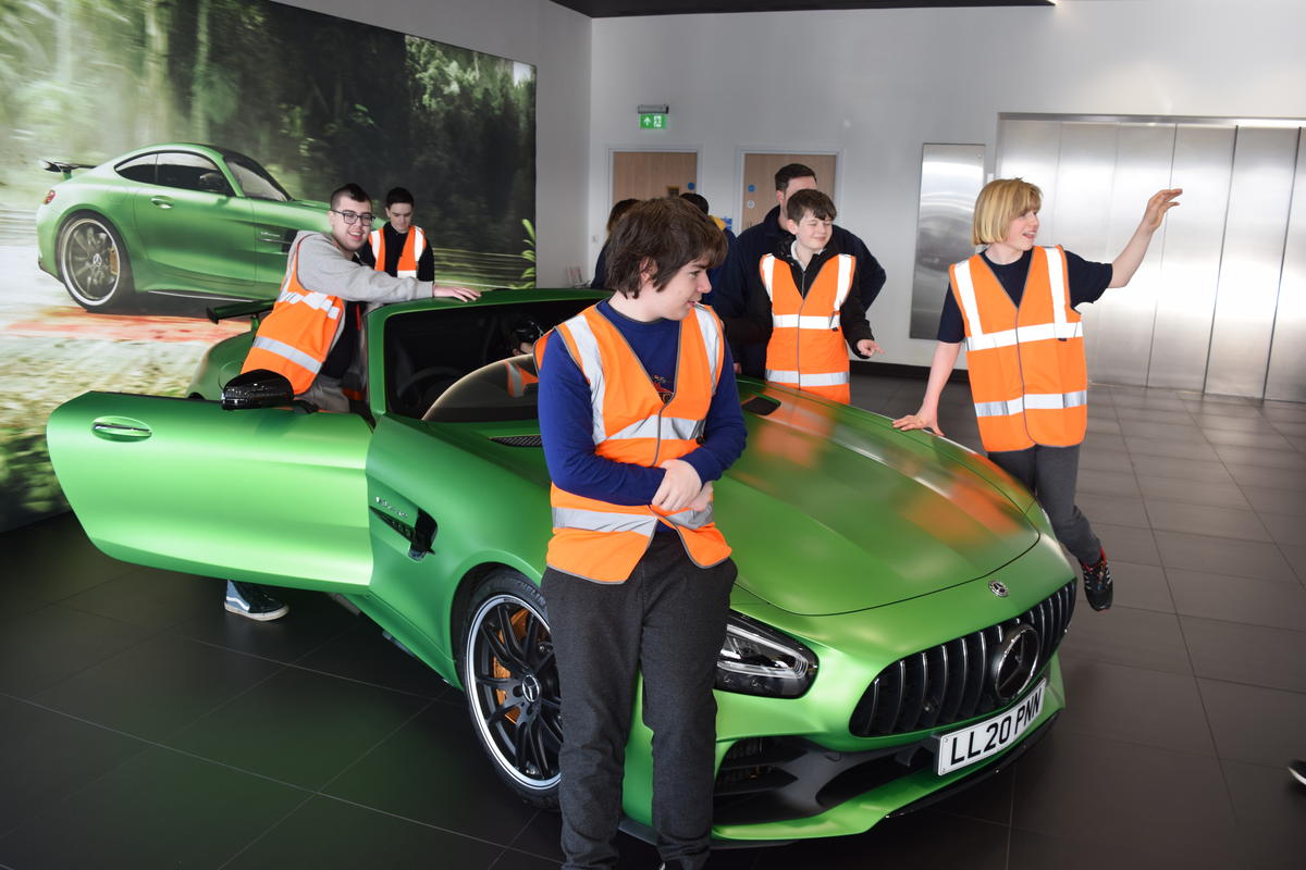 Inscape students stood around a green supercar