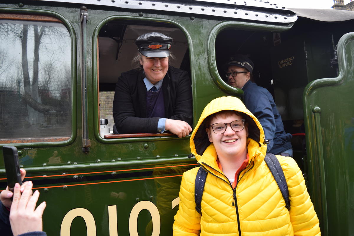 one of the students smiling with the train driver