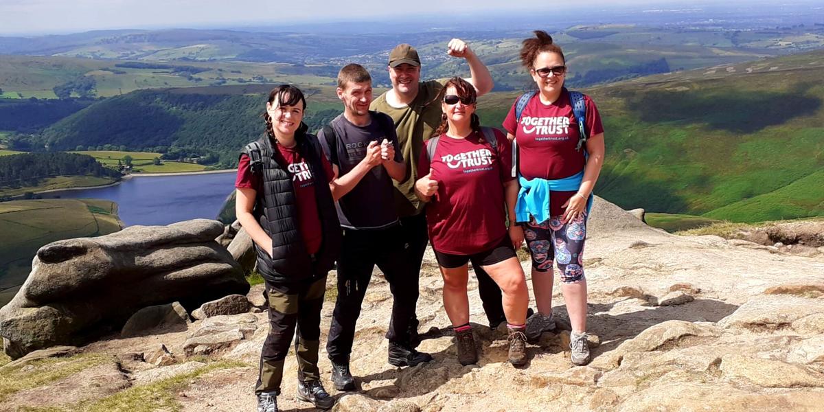 Staff members posing for a photo during their Kinder Scout challenge