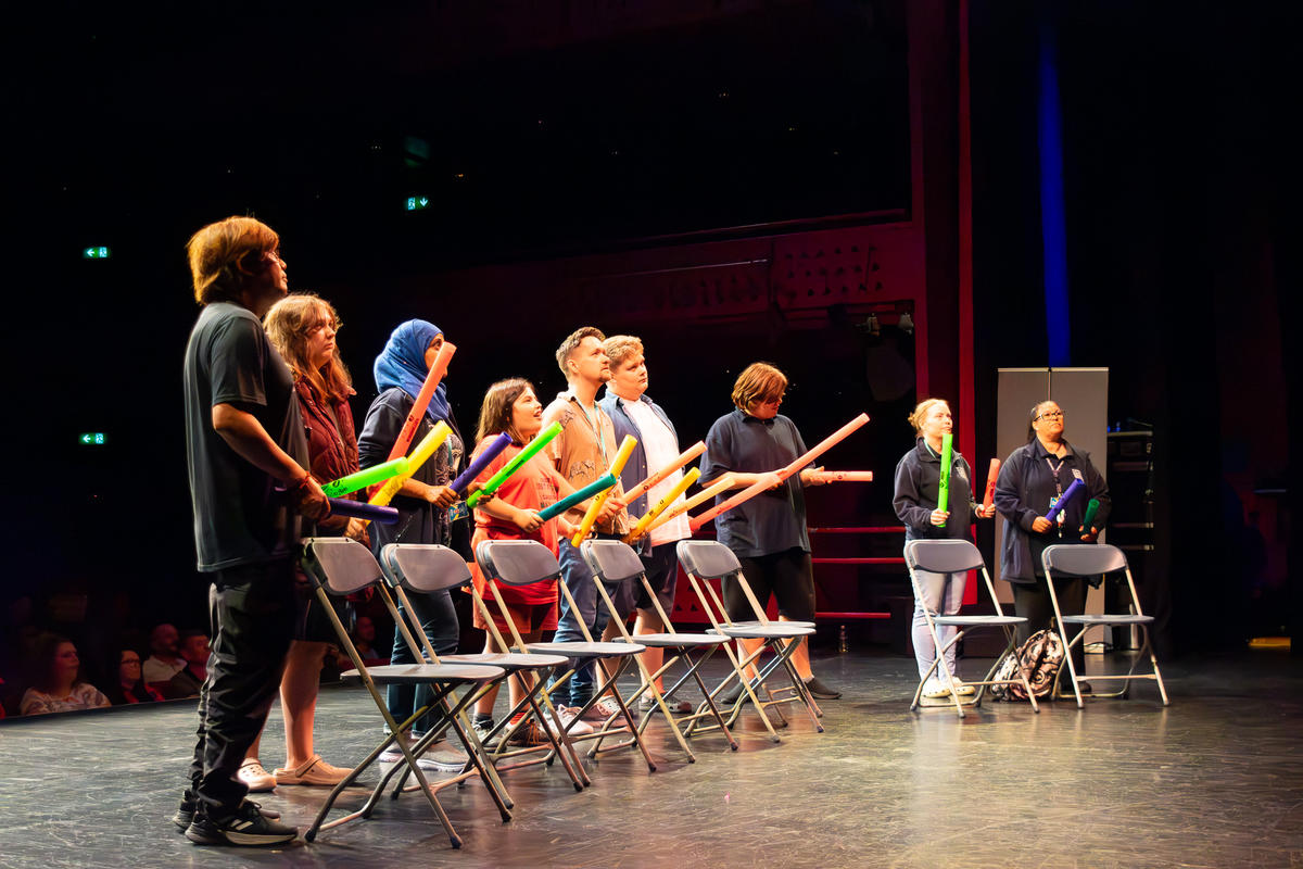 A group of students and teachers on the stage.