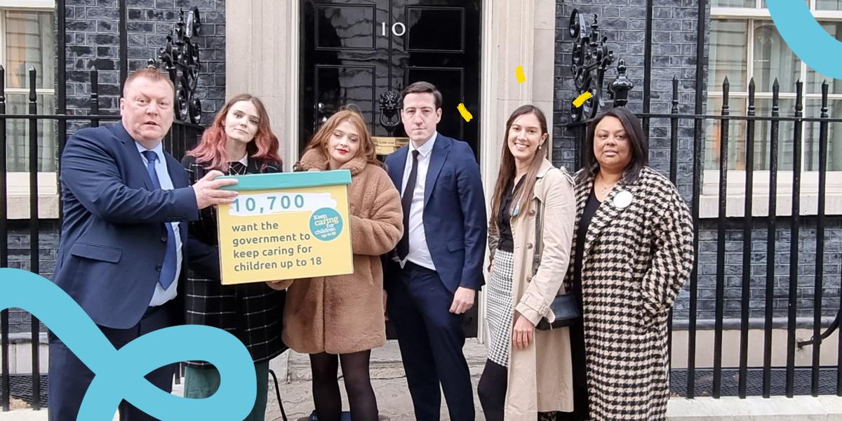 A group of young campaigners stand outside 10 Downing Street with a yellow box. It reads 10,800 people want the government to keep caring for children up to 18