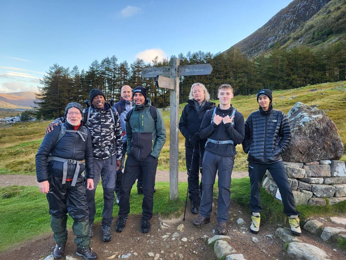 A photo of Kevin Clarke, Registered Manager at Haines House, along with his family and friends, successfully completing the final stage of the Three Peaks Challenge.