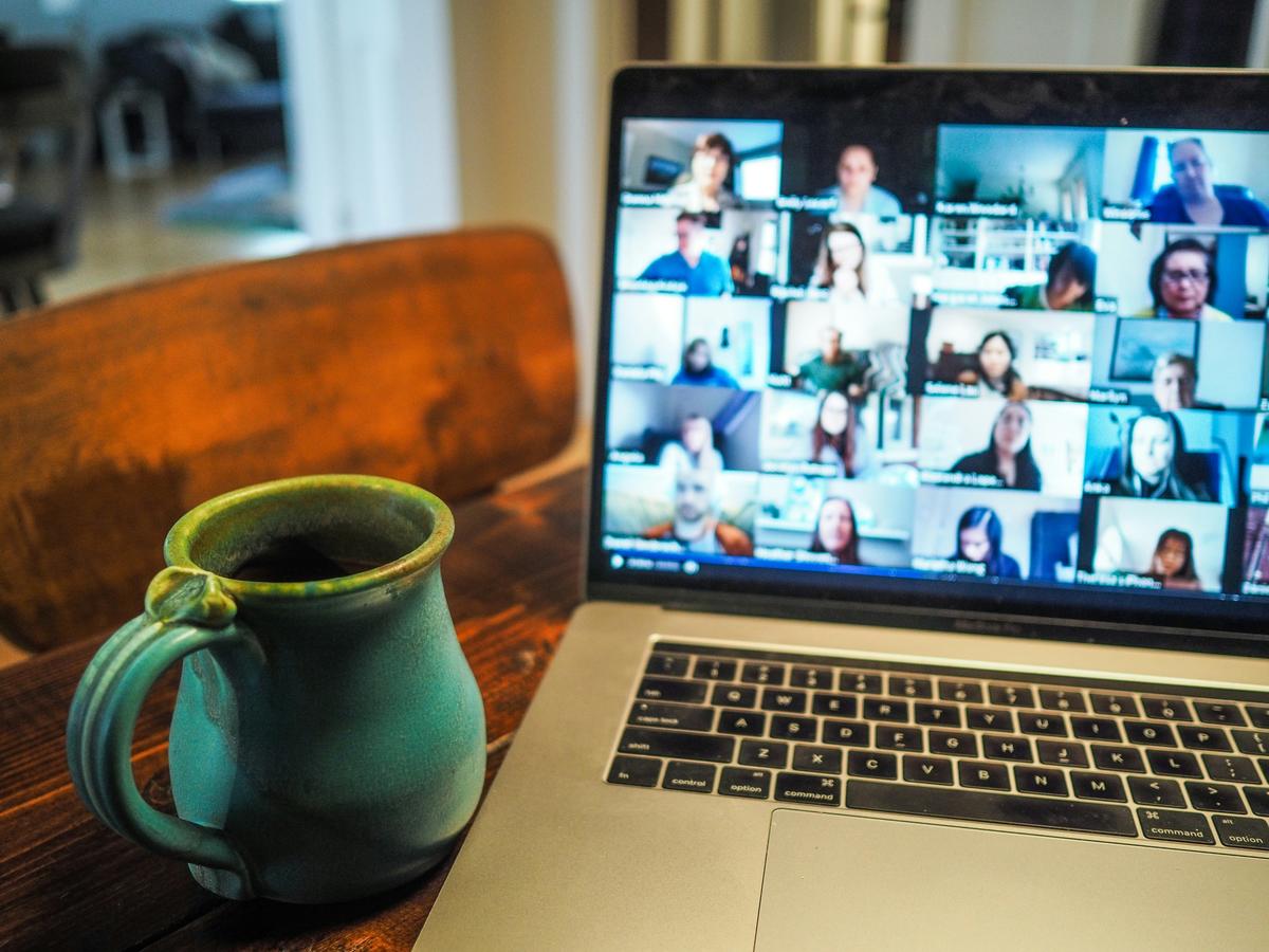 a coffee cup sat in front of a laptop screen