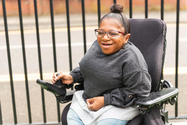 A woman in a wheelchair smiling