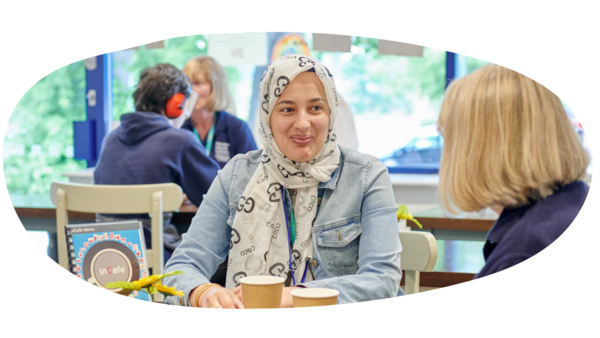 Two women sitting down having a coffee together in Inscape Cafe.