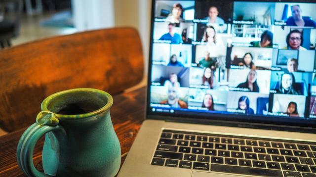 a coffee cup sat in front of a laptop screen